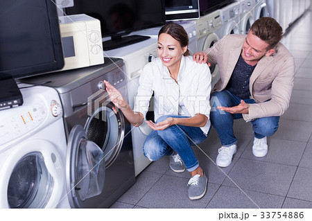 Family buying new clothes washer in supermarket 33754886