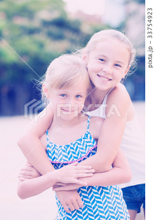 Two small happy sisters outdoors Two small happy sisters outdoors 33754923