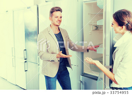 assistant in the shop sell a fridge to happy customer assistant in the shop sell a fridge to happy customer 33754955