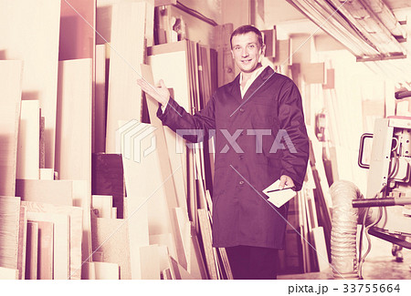 polite workman standing with plywood pieces polite workman standing with plywood pieces 33755664