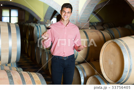 Handsome man posing in winery cellar Handsome man posing in winery cellar 33756405