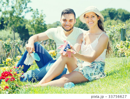 Young couple gardening together . Young couple gardening together . 33756627