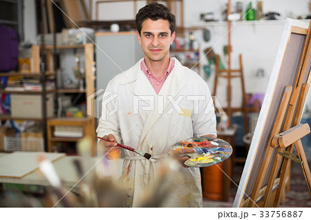 Man near easel painting on canvas Man near easel painting on canvas 33756887