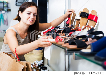 Woman buying summer shoes Woman buying summer shoes 33757116