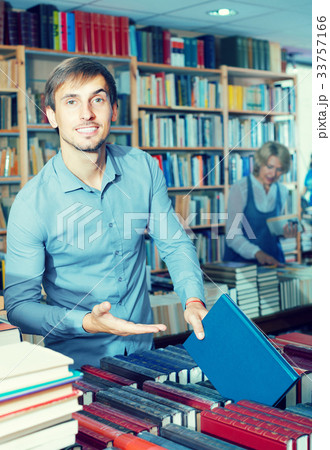 young man among bookshelves 33757166