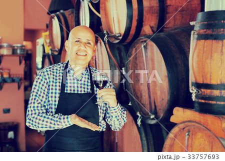 man holding wine in wine house 33757693