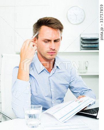 Man sitting at working and having work troubles 33757859