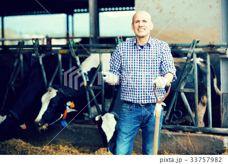 Male farmer holding agricultural tool 33757982