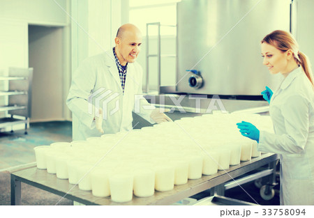 Workers working on cottage cheese 33758094
