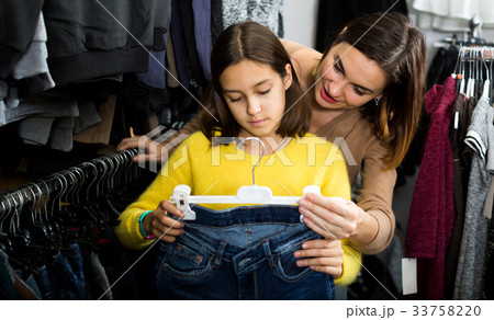 Mother and daughter deciding on new jeans Mother and daughter deciding on new jeans 33758220