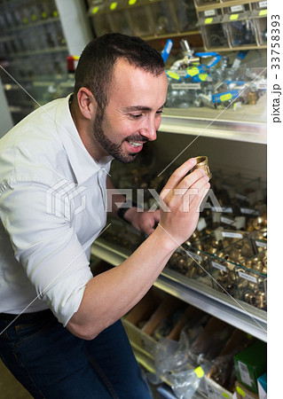 Mature cheerful man choosing metallic tap Mature cheerful man choosing metallic tap 33758393