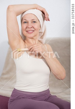 Woman doing body hair removal 33758503