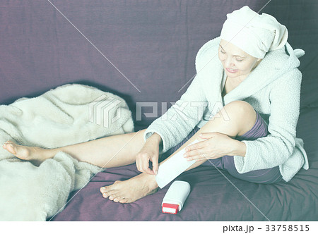 Woman doing body hair removal Woman doing body hair removal 33758515