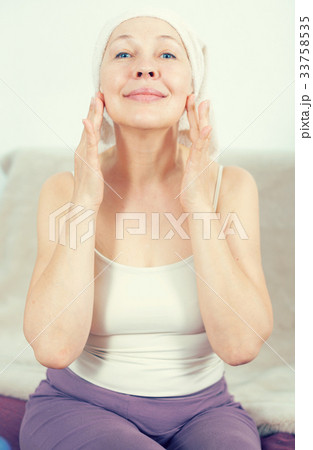 Woman using face cream 33758535