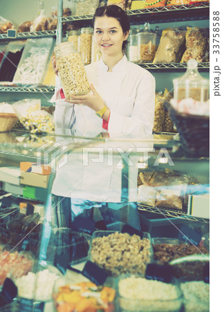 Saleswoman is offering to buy cashew 33758588