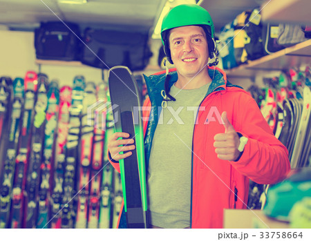 Portrait of client man in helmet and jacket who is standing with 33758664
