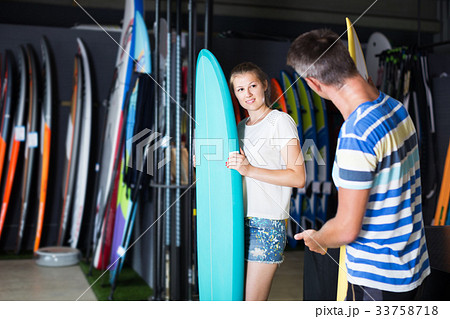 Female showing to male surfboard Female showing to male surfboard 33758718