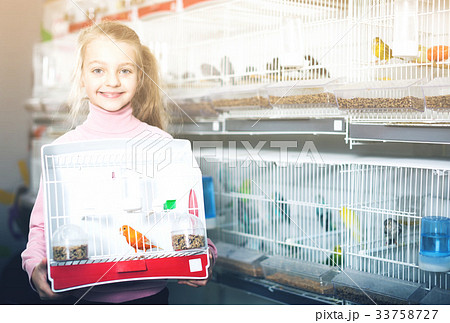 Girl enjoying her purchase of canary bird 33758727