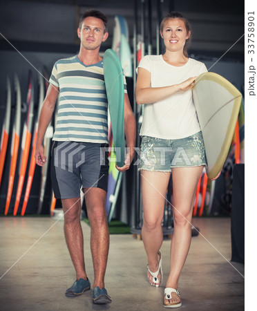 Couple with new surfboard 33758901