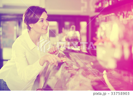 Woman choosing dessert Woman choosing dessert 33758903