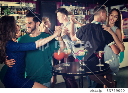 Couple dancing passionately in pair in the nightclub Couple dancing passionately in pair in the nightclub 33759090