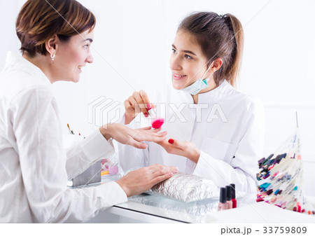 Woman doing manicure 33759809