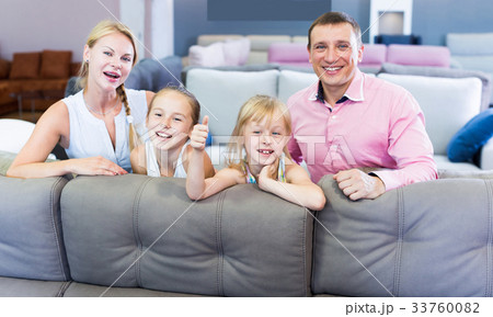 Family are choosing new sofa in furniture store. 33760082