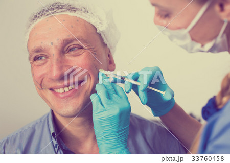 Female specialist is doing injection to client for anti-aging 33760458