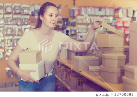 Female with smile looking multi colored boxes 33760693