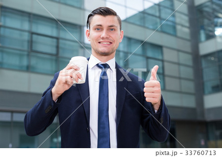 Successful businessman is drinking coffee outdoors 33760713