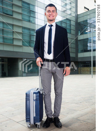 Successful adult businessman in suit with suitcase is staying 33760788