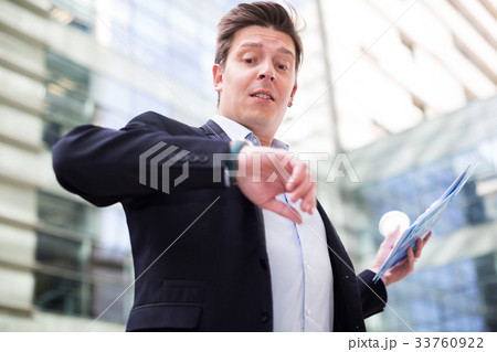 Man in jacket with documents hurrying to meeting Man in jacket with documents hurrying to meeting 33760922