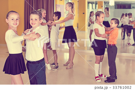 Little boys and girls having dancing class in classroom 33761002