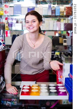 woman seller showing diverse assortment in shop 33761052