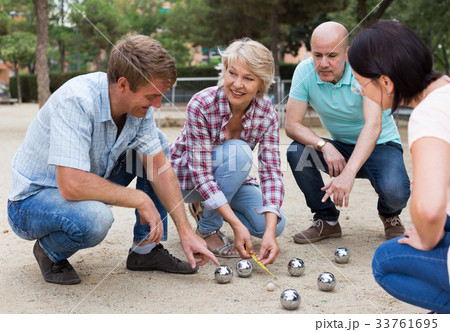 friendly mature couples playing petanque at leisure 33761695