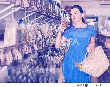 Customer choosing candied fruits Customer choosing candied fruits 33761753