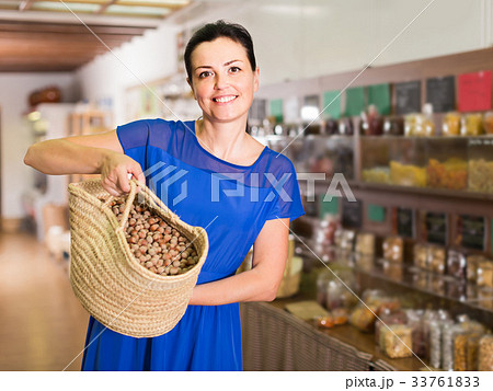 woman displayed big shopping bag with nuts in eco market 33761833