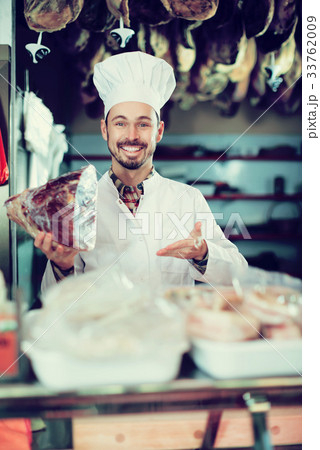 Seller offering piece of meat 33762009