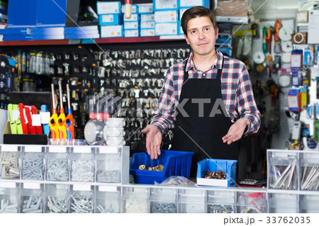 worker in hardware store trading goods for water tap in uniform 33762035