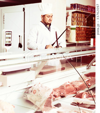 Male butcher in kosher section at supermarket 33762097