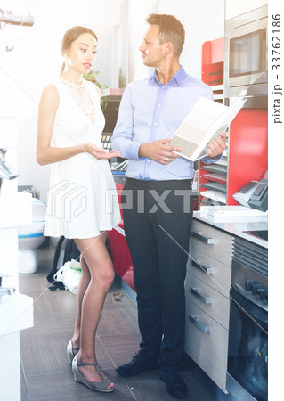Adult husband and wife are choosing material for countertop Adult husband and wife are choosing material for countertop 33762186