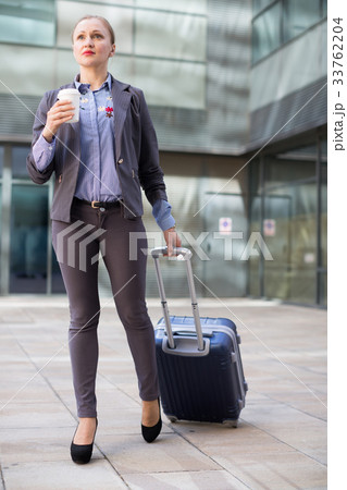 Smiling woman with baggage and coffee 33762204
