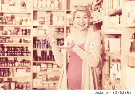 Woman client looking for reliable skin care products Woman client looking for reliable skin care products 33762369
