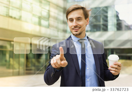 Business man pressing virtual buttons Business man pressing virtual buttons 33762723