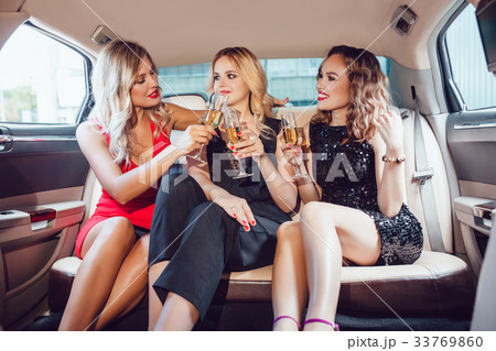 Pretty women having party in a limousine car and Pretty women having party in a limousine car and 33769860