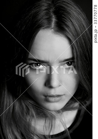 Young beautiful girl. Hard serious look at the 33770778