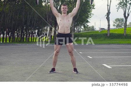 A young man is lifting barbell A young man is lifting barbell 33774498