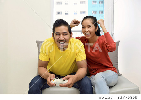 Asian couple playing video games and having fun 33776869