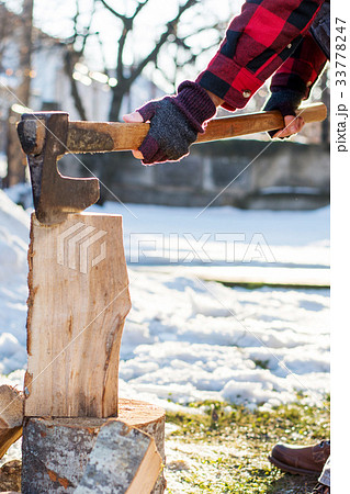 Man cutting firewood for the winter 33778247