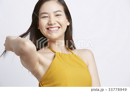a girl is stroking her hair and laughing 33778949